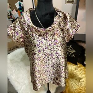 Artsy fashion fun in this multi-colored shortsleeved blouse